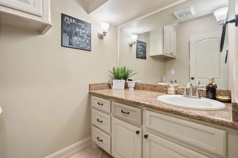 a view of staircase with railing and white walls