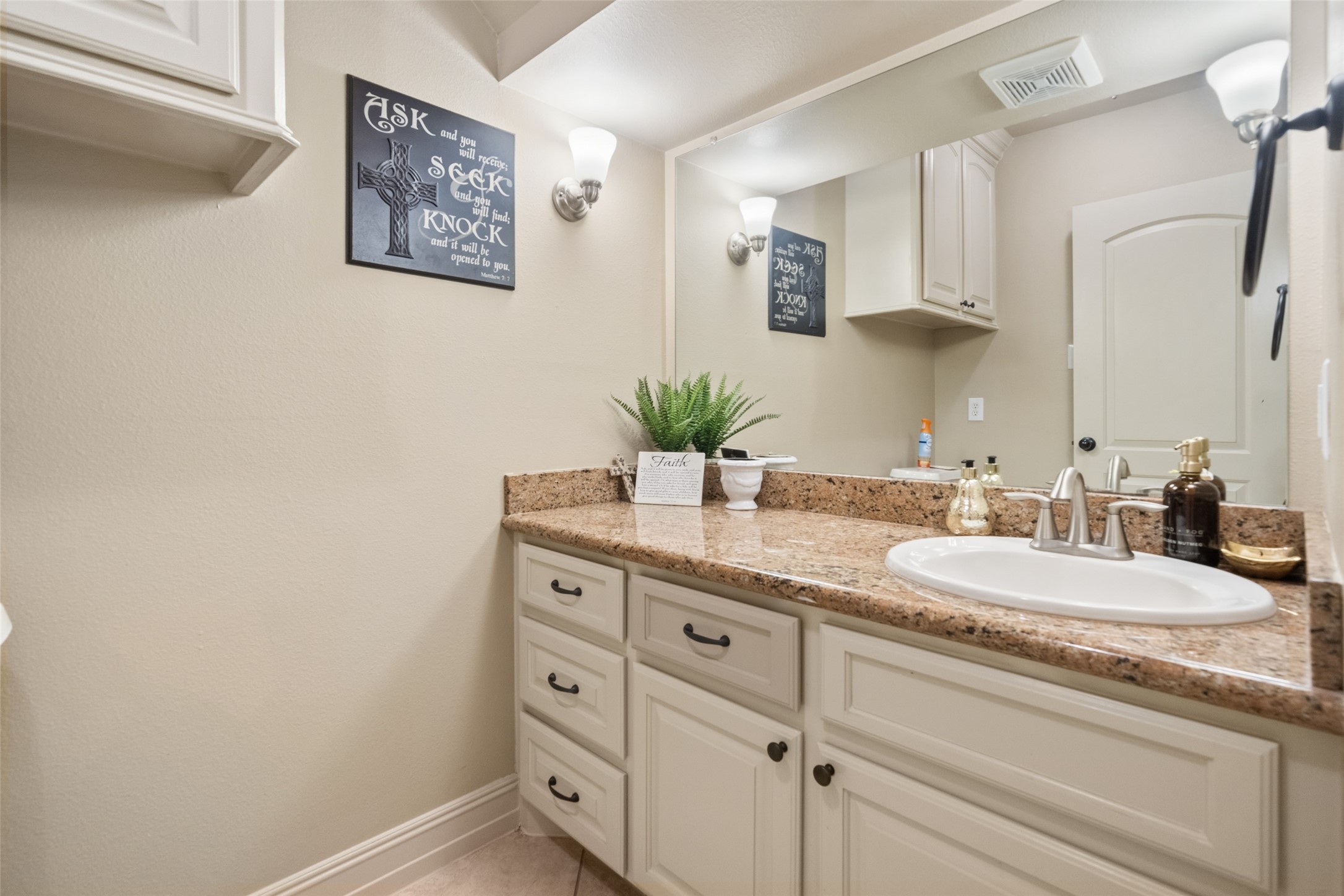 255 Capetown Way Conroe, TX 77356 - Photo 14 of 30 a bathroom with a granite countertop sink a mirror and a