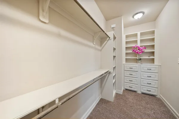 a bathroom with a double vanity sink a mirror and a bathtub