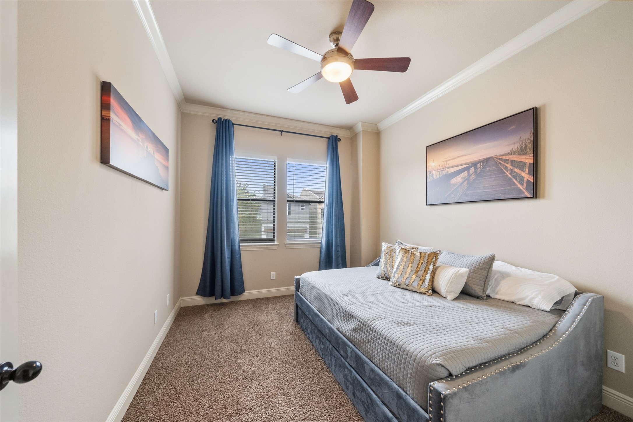 255 Capetown Way Conroe, TX 77356 - Photo 24 of 30 a bedroom with a bed and a chandelier