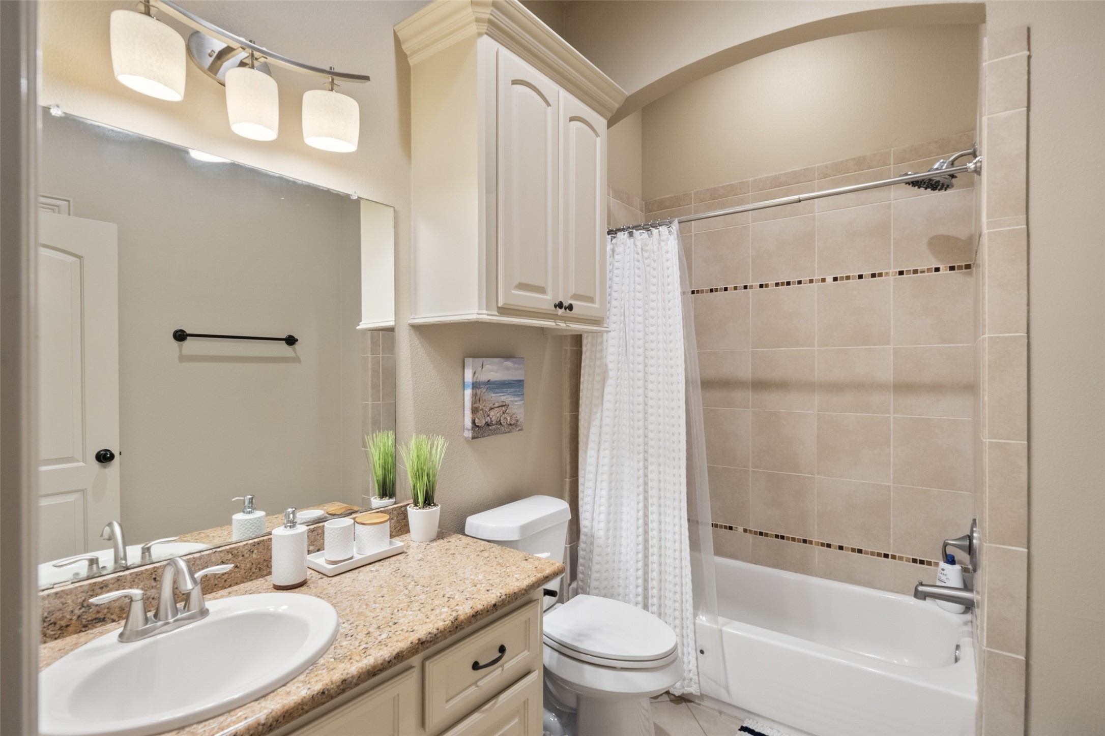 255 Capetown Way Conroe, TX 77356 - Photo 25 of 30 a bathroom with a granite countertop sink toilet and shower