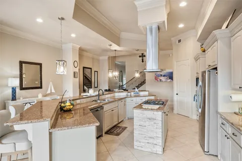 a kitchen with stainless steel appliances kitchen island granite countertop a sink and cabinets