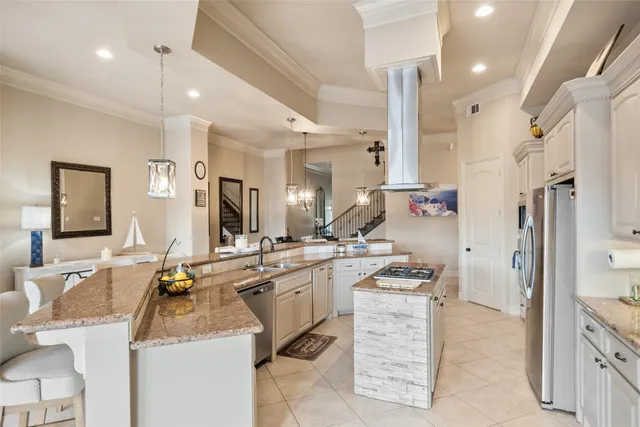 a kitchen with stainless steel appliances kitchen island granite countertop a sink and cabinets
