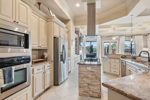 a dining table with chairs and kitchen view