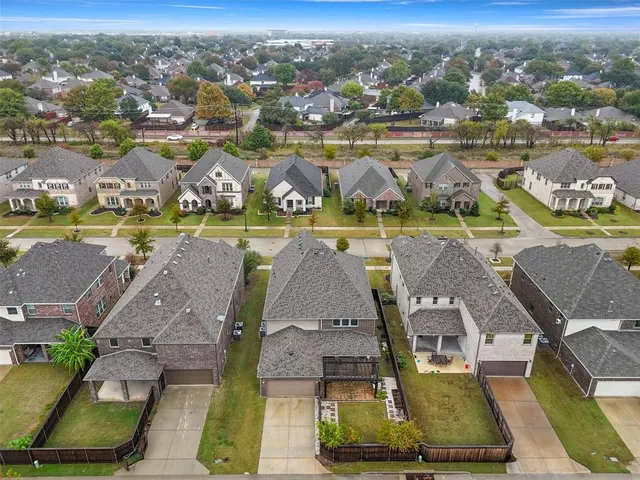 an aerial view of residential houses with outdoor space