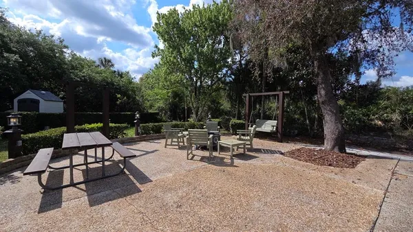 a view of a backyard with sitting area