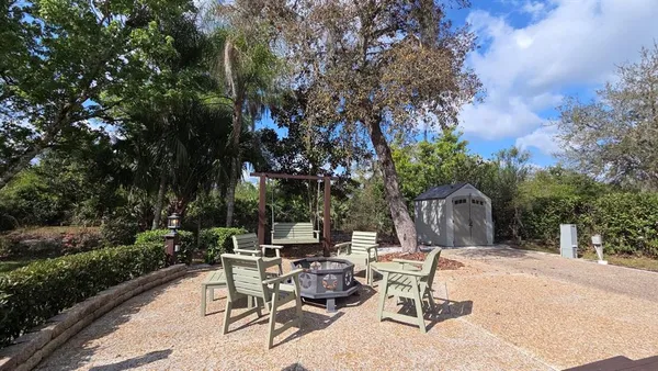 a view of a patio with table and chairs and potted plants