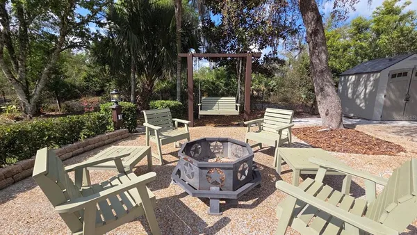 a view of a patio with table and chairs and potted plants