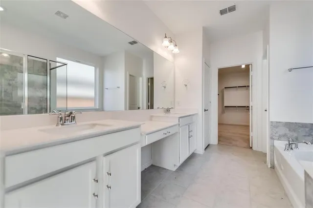 a bathroom with a double vanity sink and a mirror