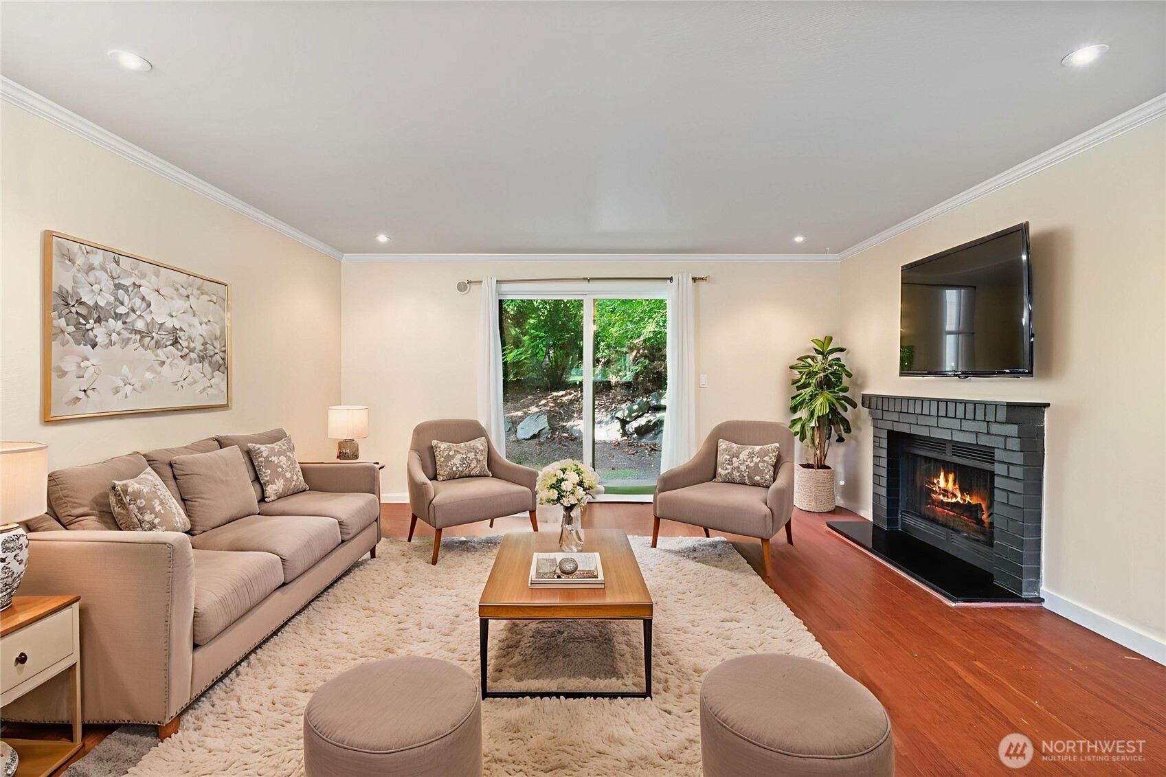 a living room with furniture a flat screen tv and a fireplace