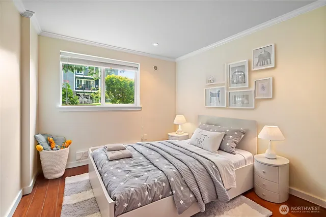 a bedroom with a bed and wooden floor