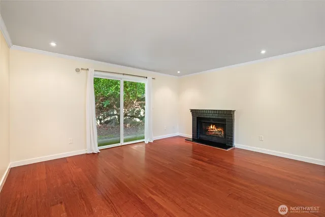 a view of empty room with a fireplace