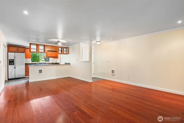 a view of an empty room with wooden floor