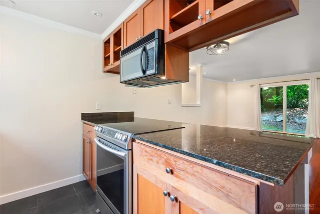 a kitchen with stainless steel appliances granite countertop a sink and a microwave