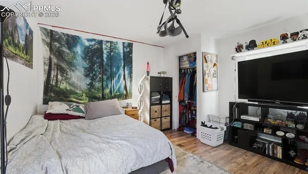 a bedroom with a bed and a flat screen tv