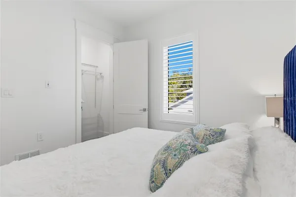 a bedroom with a bed and a window in it