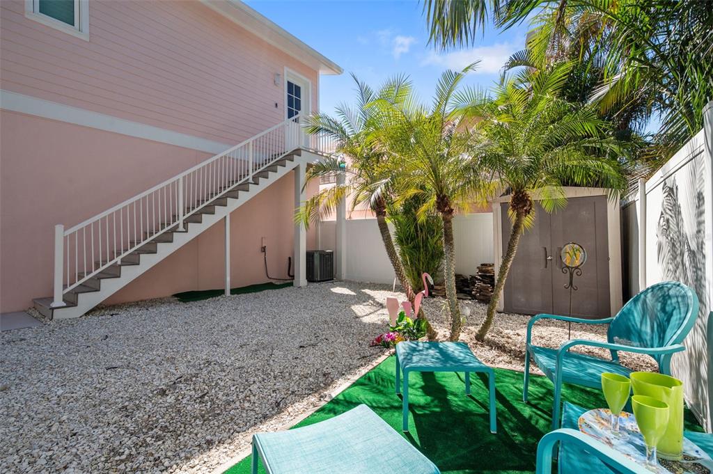 345 Bailey Street, Unit A Safety Harbor, FL 34695 - Photo 18 of 21 a backyard of a house with table and chairs