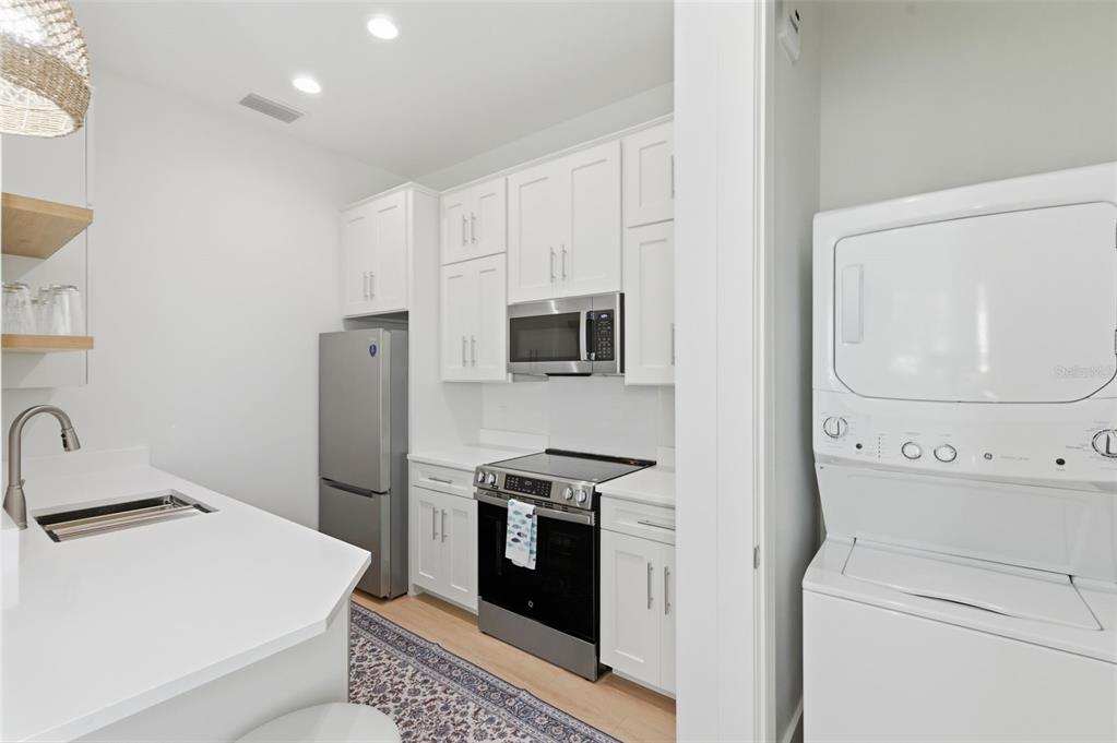 345 Bailey Street, Unit A Safety Harbor, FL 34695 - Photo 8 of 21 a kitchen with a stove and a refrigerator