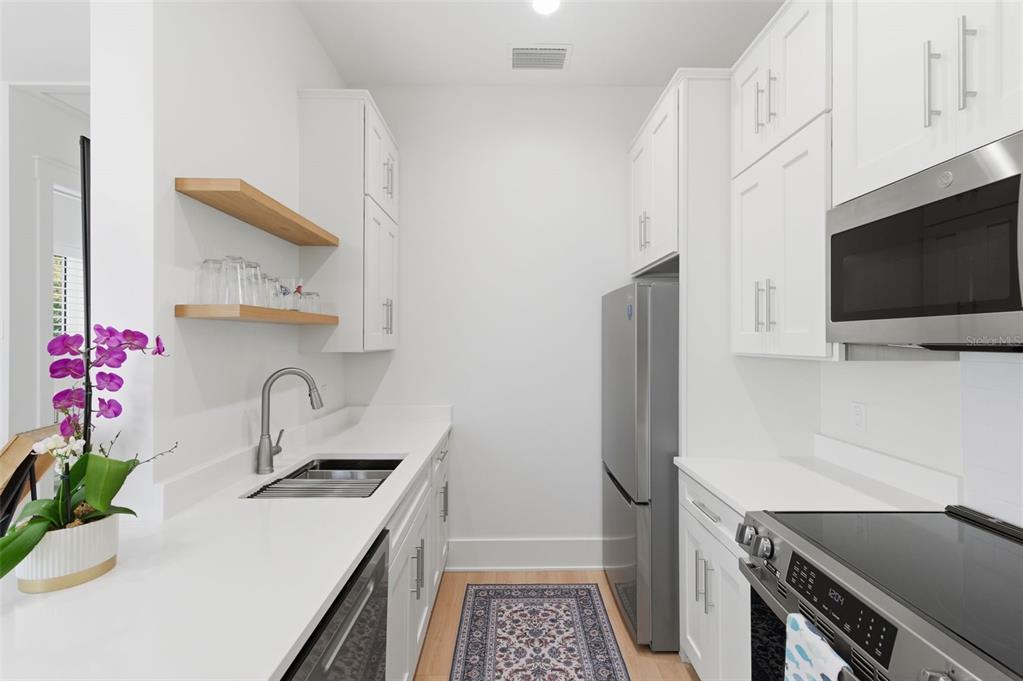 345 Bailey Street, Unit A Safety Harbor, FL 34695 - Photo 9 of 21 a kitchen that has a sink and a stove in it