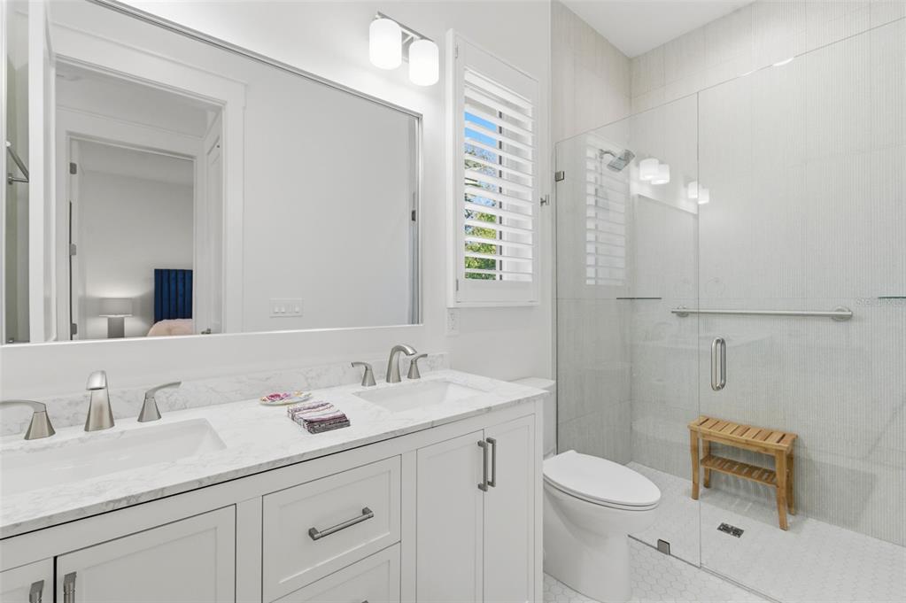 345 Bailey Street, Unit A Safety Harbor, FL 34695 - Photo 10 of 21 a bathroom with a sink vanity granite toilet and a mirror