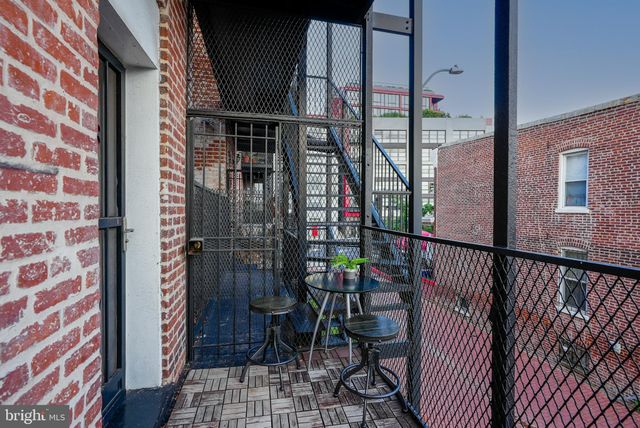 a balcony with table and chairs