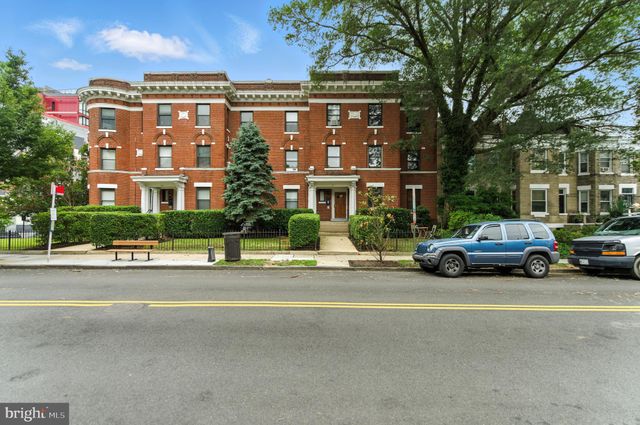 a view of a car parked in front of a building