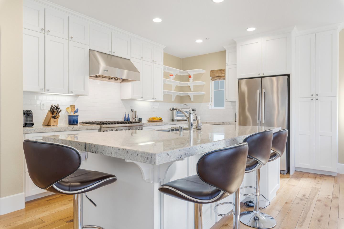 107 Savannah Loop Mountain View, CA 94043 - Photo 6 of 29 a kitchen with kitchen island stainless steel appliances a stove a sink a refrigerator cabinets and dining table