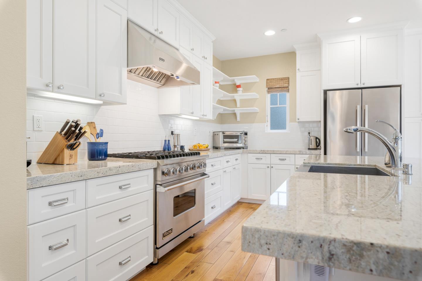 107 Savannah Loop Mountain View, CA 94043 - Photo 7 of 29 a kitchen with stainless steel appliances granite countertop a sink a stove and cabinets