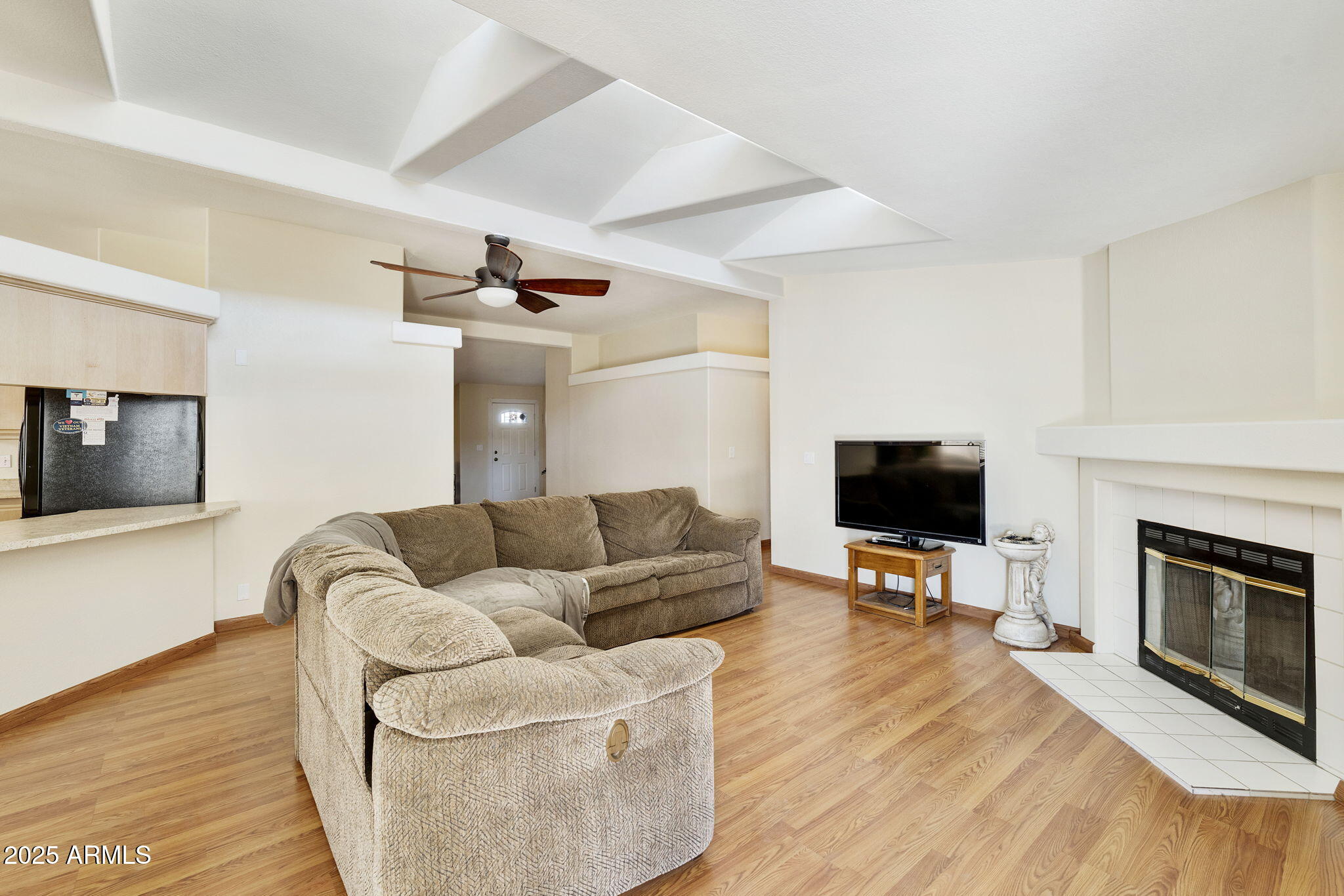 3700 South Tomahawk Road, Unit 83 Apache Junction, AZ 85119 - Photo 18 of 31 a living room with furniture a fireplace and a flat screen tv