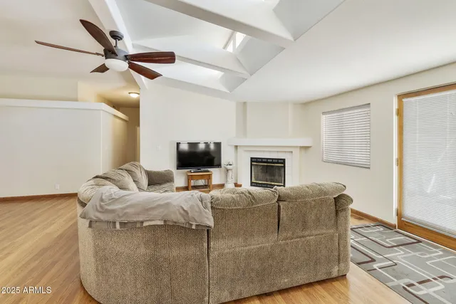 a living room with furniture a fireplace and a flat screen tv