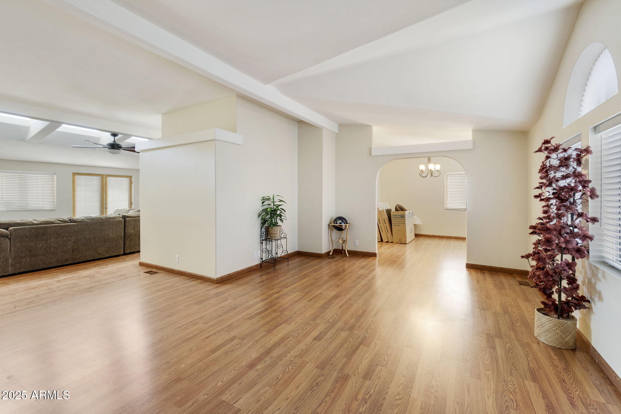 3700 South Tomahawk Road, Unit 83 Apache Junction, AZ 85119 - Photo 25 of 31 a view of an empty room with potted plants and wooden floor