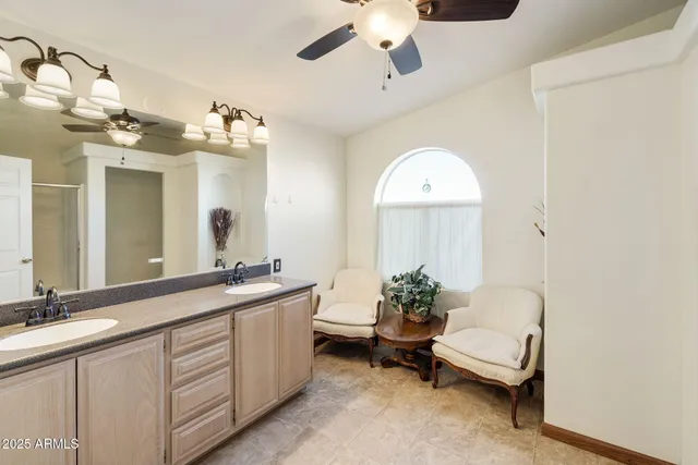 a spacious bathroom with a double vanity sink and a mirror