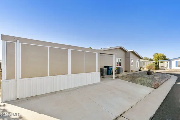 a view of house with backyard and sitting area