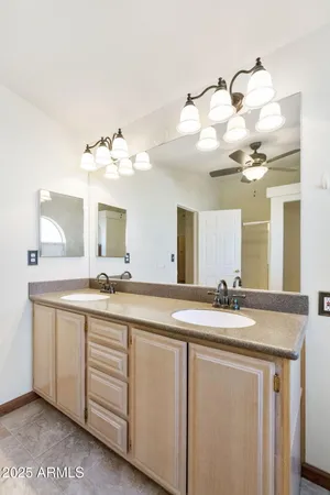 a bathroom with a sink a vanity and mirror