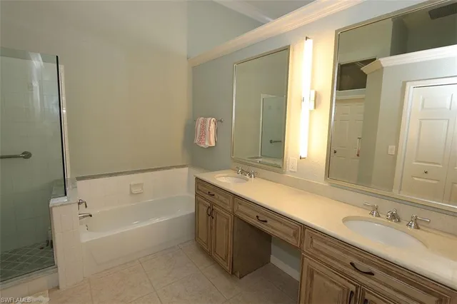 a bathroom with a tub sink double and mirror