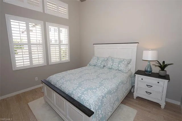 a bed sitting in a bedroom next to a window