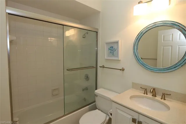 a bathroom with a sink toilet and a mirror