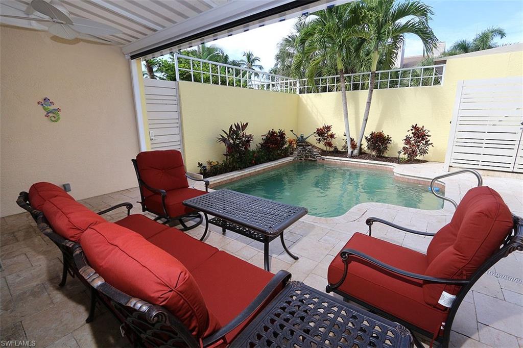 1080 5th Street South, Unit 1080 Naples, FL 34102 - Photo 20 of 21 a view of a chairs and table in the roof deck