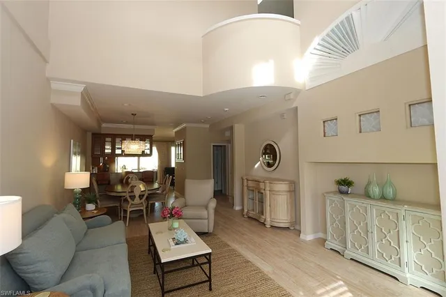 a living room with furniture and a chandelier