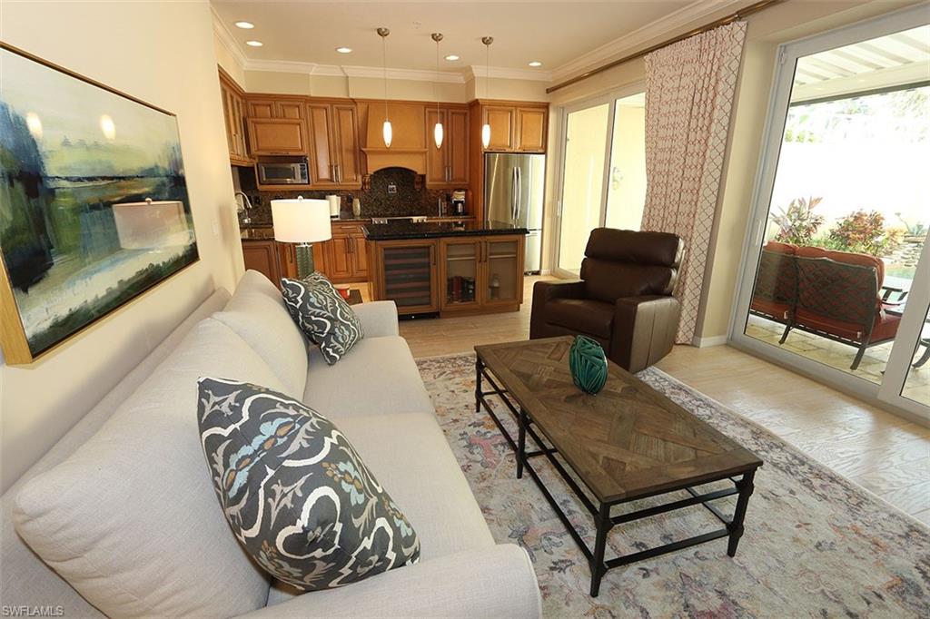 1080 5th Street South, Unit 1080 Naples, FL 34102 - Photo 9 of 21 a living room with furniture and a flat screen tv