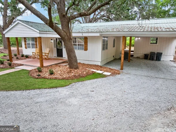 a front view of a house with a yard and a garage