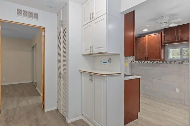 a view of cabinets and wooden floor