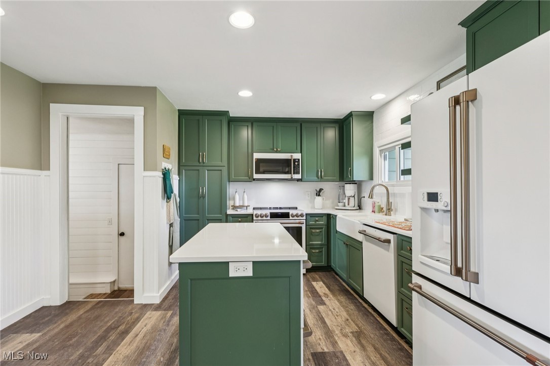 6147 Stone Road Medina, OH 44256 - Photo 15 of 40 Kitchen with green cabinets, smart appliances, a center island, dark wood-style flooring, and recessed lighting