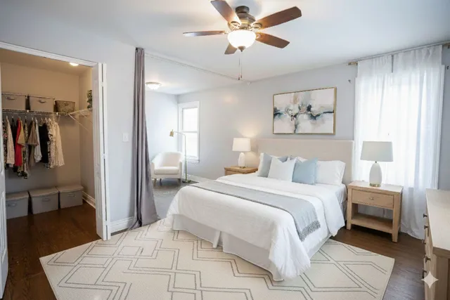 a bedroom with a bed and a chandelier