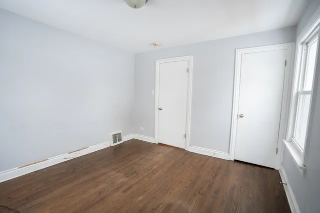 an empty room with wooden floor