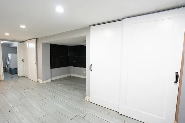 a view of entryway with white walls and white door