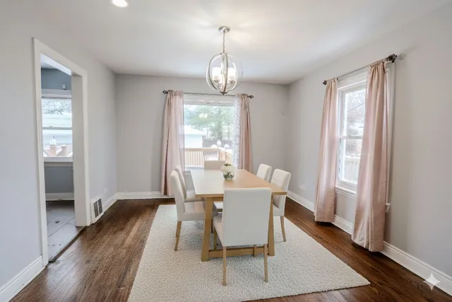 a view of a dining room with furniture wooden floor and a chandelier
