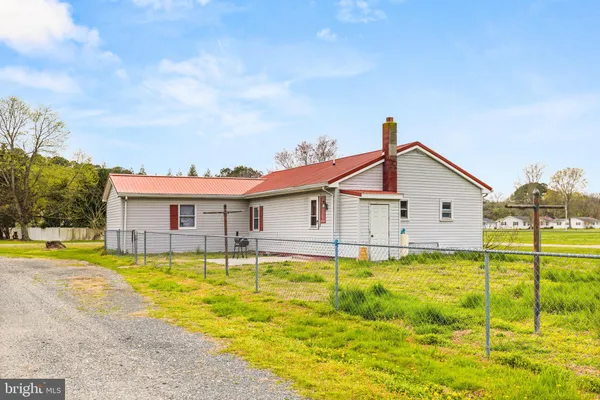 a view of a house with a swimming pool and a yard