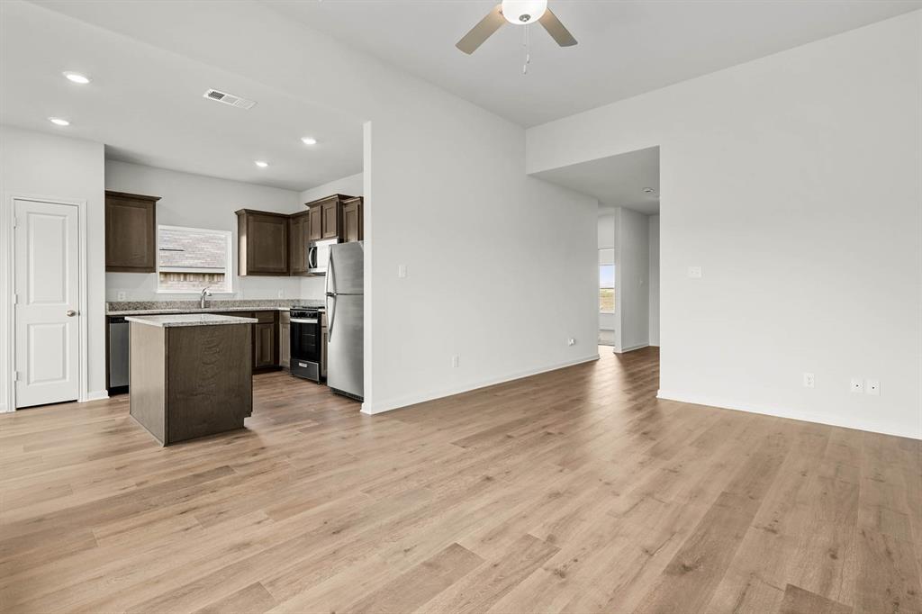 418 Watson Court Venus, TX 76084 - Photo 3 of 10 a view of kitchen with wooden floor and electronic appliances