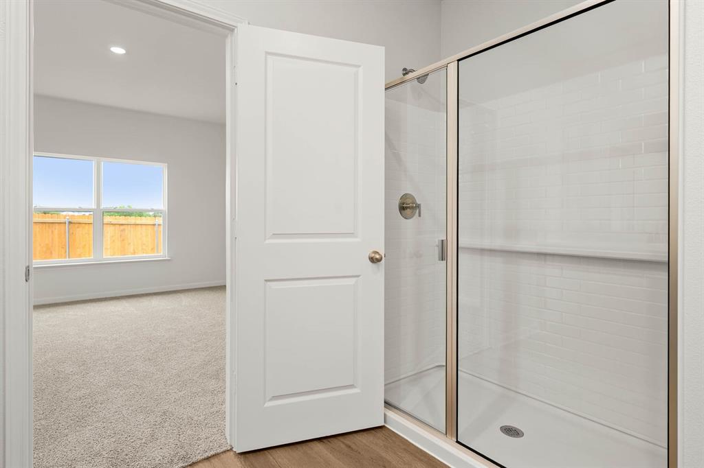 418 Watson Court Venus, TX 76084 - Photo 7 of 10 a bathroom with a glass shower door